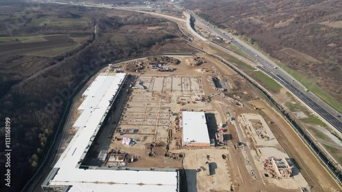 Aerial view on huge construction site with heavy equipment and workers.