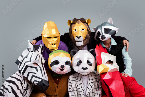 Portrait of zebra gorilla raccoon lion panda sloth rooster mask people embrace isolated on grey color background photo