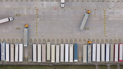 Top down aerial view of trucks at distribution center in the United Kingdom. Logistics and delivery concept.