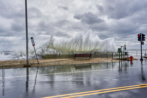 Fototapeta Naklejka Na Ścianę i Meble -  Large waves crashing into the streets and flooding it.