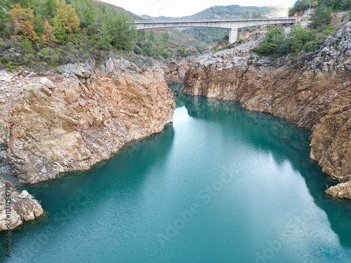 reservoir with emerald water rocky shore photo