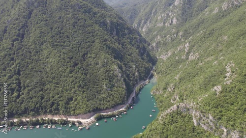 Aerial view on beautiful mountain lake surrounded with forest and mountains