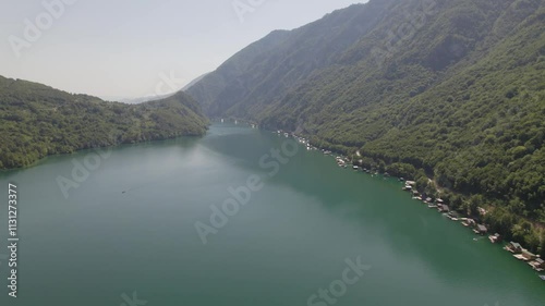 Aerial view on beautiful mountain lake surrounded with forest and mountains