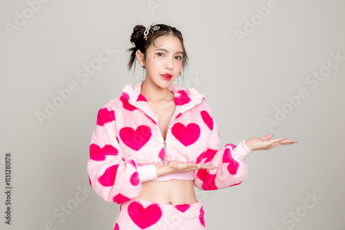 Young Pretty Asian woman have prefect slim fit body in heart print dress with makeup on face hands open palms presenting isolated on white background. Valentine, love, plastic surgery concept. photo