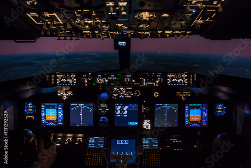 Inside the cockpit of a passenger aircraft flying at dusk