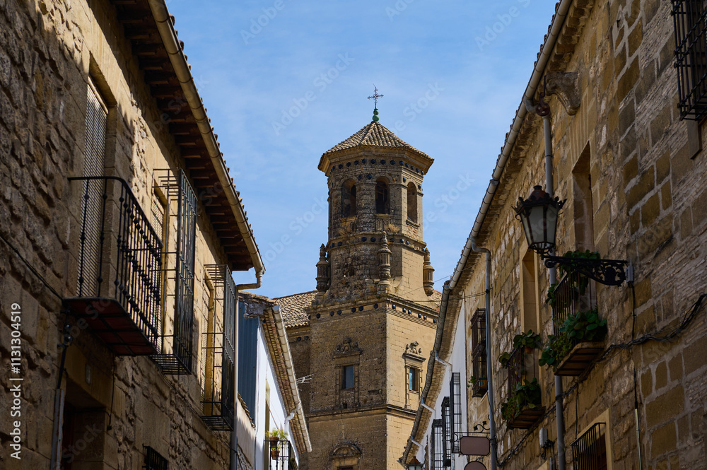 Fototapeta premium Historic stone buildings and tower against clear blue sky