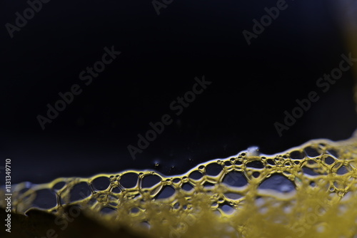 Bright bubbles at the bottom of the picture, minimalistic background, Yellow bubbles on black background, liquid abstraction  photo