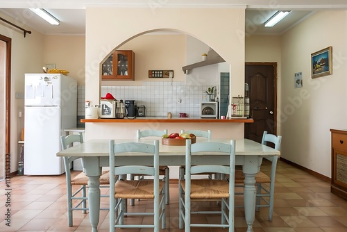 Dining table in interior of kitchen with fridge and counter