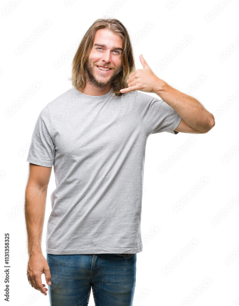 Fototapeta premium Young handsome man with long hair over isolated background smiling doing phone gesture with hand and fingers like talking on the telephone. Communicating concepts.