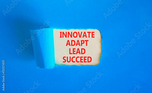 Innovate adapt lead succeed symbol. Concept words Innovate Adapt Lead Succeed on beautiful white paper. Beautiful blue table blue background. Business innovate adapt lead succeed concept. Copy space. photo