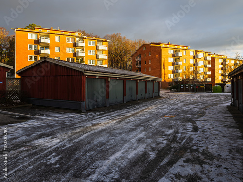 Foto Residential area with garages and apartment buildings under cloudy sky during la