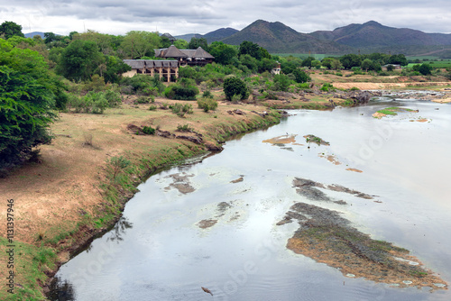 Shallow Crocodile River in Kruger National Park, Mpumalanga Province, South Africa. Crocodiles rest on the shore.	 photo