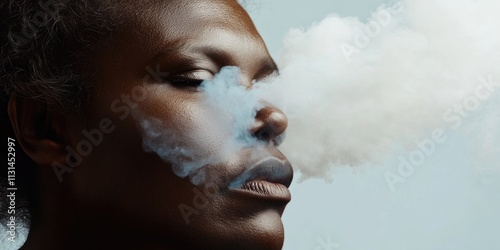 A woman is blowing smoke into her face as she looks away, possibly indicating frustration or annoyance photo