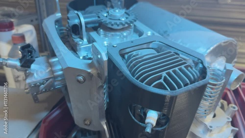 Internal combustion engine parts are on the rack in the workshop, Cylinder block, exhaust system, spark plugs, shafts and bearings, Dolly shot.