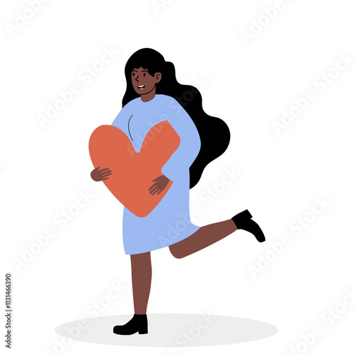 Joyful woman holding a large heart shape while running in a playful manner
