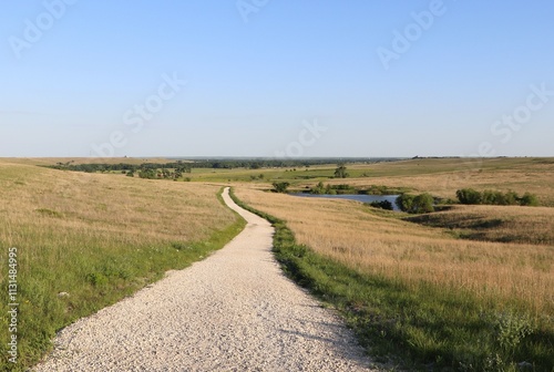 Hiking trail along prairie meadows in the Flint Hills of Southern, central Kansas.