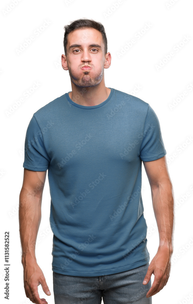 Fototapeta premium Handsome young casual man puffing cheeks with funny face. Mouth inflated with air, crazy expression.