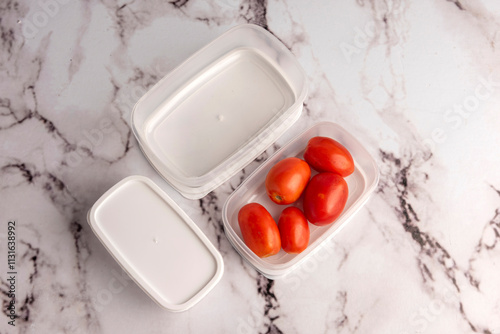 Multipurpose plastic food containers for vegetables, meats, cheeses on a kitchen counter