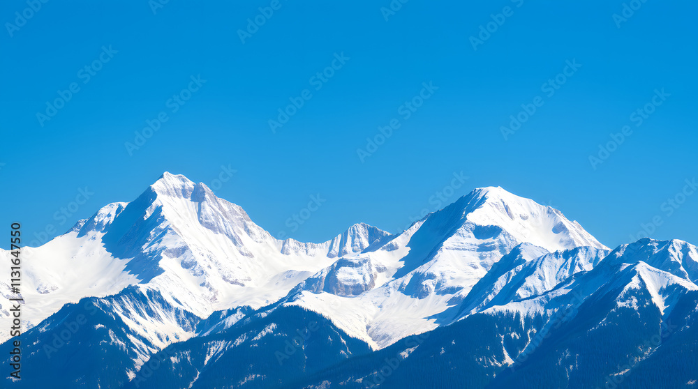 Obraz premium Snow-capped mountain peaks against a clear blue sky