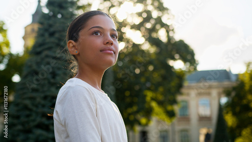 Multiethnic young little girl american indian latino student gen z teenager smiling happy schoolgirl female child kid adopt daughter primary school education student pupil learner posing outdoors city photo