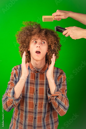 A boy with curly hair sits calmly as a trimmer removes his locks, the bright green chroma key background offering a seamless and versatile base for digital media and design purposes. photo