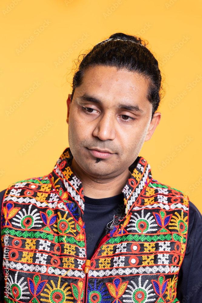 Fototapeta premium Pensive man reflecting, lost in daydreaming process, isolated over studio background. Distracted indian person in traditional clothing fantasizing, using imagination, studio backdrop