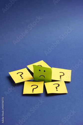 Fotografie Sad face surrounded by question marks represents inner doubts, emotional dilemmas, and decision-making confusion