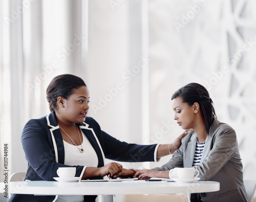 Care, women and support in office with empathy, listen or solidarity with holding hands. Female people, comfort and compassion for grief counselling, conversation and mental health at work or company photo