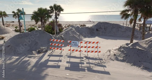 Hurricane Milton aftermath cleanup. Roadblock sign and piles of sand at Englewood Beach on Manasota Key. photo