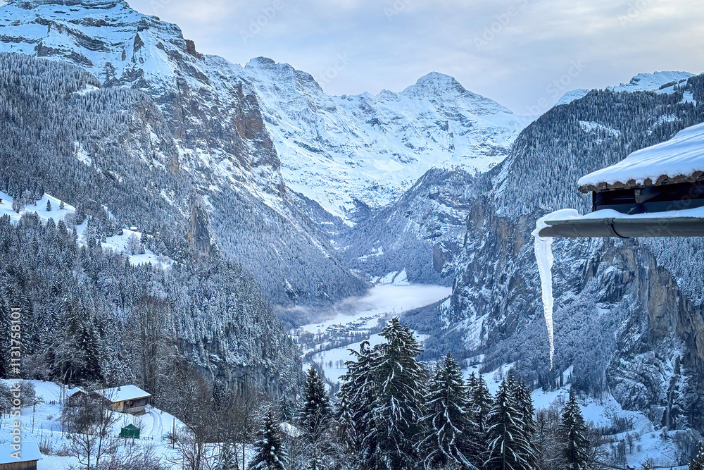 Scenic view of Lauterbrunnen Valley, Switzerland seen from Wengen with snowcovered Breithorn mountain in winter against blue sky with clouds