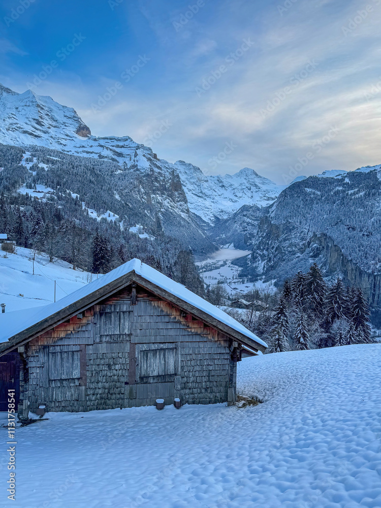 Scenic view of Lauterbrunnen Valley, Switzerland seen from Wengen with snowcovered Breithorn mountain in winter against blue sky with clouds