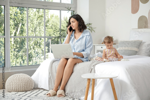 Working mother and her litt...