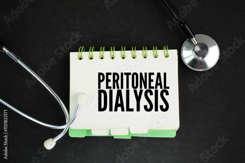 stethoscope and paper with the word peritoneal dialysis. treatment for kidney failure that uses the lining of your abdomen or belly.
