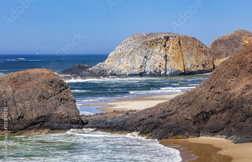 Panoramic seascape of the rocky mountainous central Oregon Pacific coast with a clear blue sky 