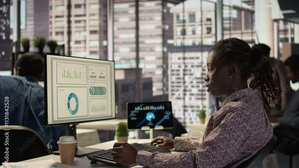 African american staff analyzing financial data for strategic planning, debating resource allocation for effective business operations. Analyst does financial forecasting and analysis. Camera B.