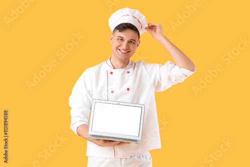 Male chef with blank laptop...