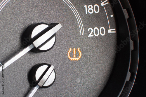 Tire pressure warning light on car dashboard , Automotive repair concept