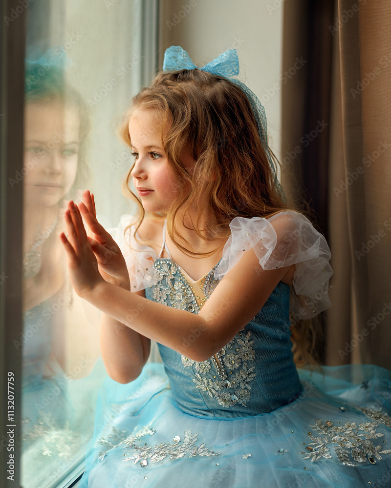 A ballerina girl in a ballet skirt and pointe shoes poses with Little adorable child ballerina in ballet tutu practicing classic choreography in ballet school, in studio