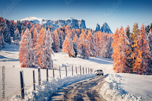 Drivind on the snowy road in Alpe di Siusi ski resort. Snowy winter landscape of Dolomite Alps. Splendid  outdoor scene of Dolomite Alps, Ityaly, Europe. Beauty of nature concept background. photo