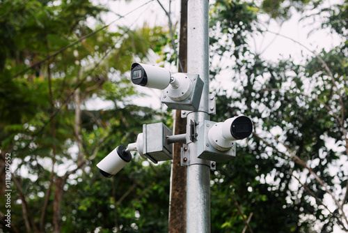 3 CCTV cameras installed on a round steel pole, leaving space for copying