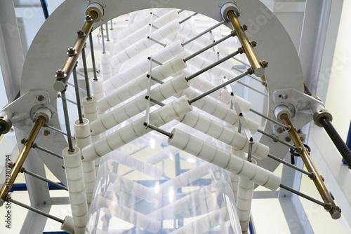 Plastic film roll on winding unit of Blown film plastic bag-making machine.