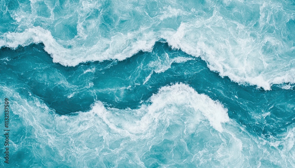 Fototapeta premium Aerial view of vibrant blue ocean waves, creating dynamic patterns through frothy white surf and tranquil turquoise water.