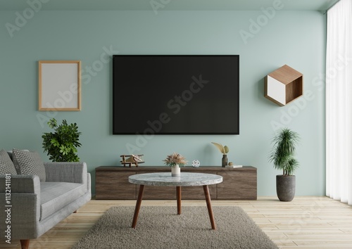 Living room has a large TV on the blue wall, beautifully decorated.