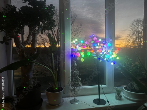 colorful sunrise sky outside the window, colorful play of light, shadows and reflections on the window glass, blurred outlines, winter
