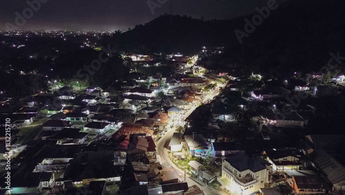 Aerial view of a small town in the mountains at night.