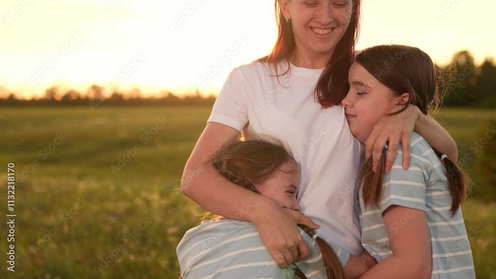Obraz premium Family reunion field, Children running mom, Outdoor fun during sunset, Happy family moments, Summer evening joy, Kid mom embrace, Warm sunset nature, Family bonding time, Scenic outdoor playtime.