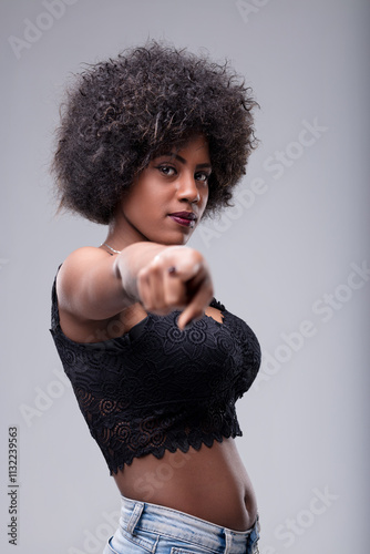 Young woman pointing finger with determined expression