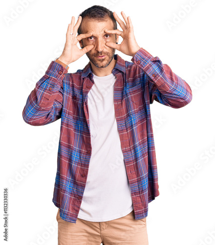 Young handsome man wearing casual clothes trying to open eyes with fingers, sleepy and tired for morning fatigue