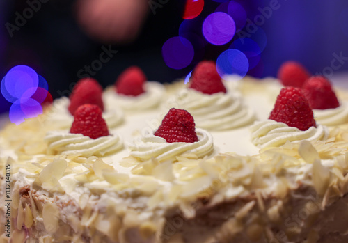 A delicious and tempting cake decorated with almonds and raspberries