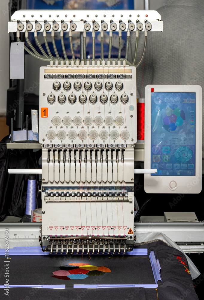 Intricate embroidery machine in action creating colorful designs in a workshop setting